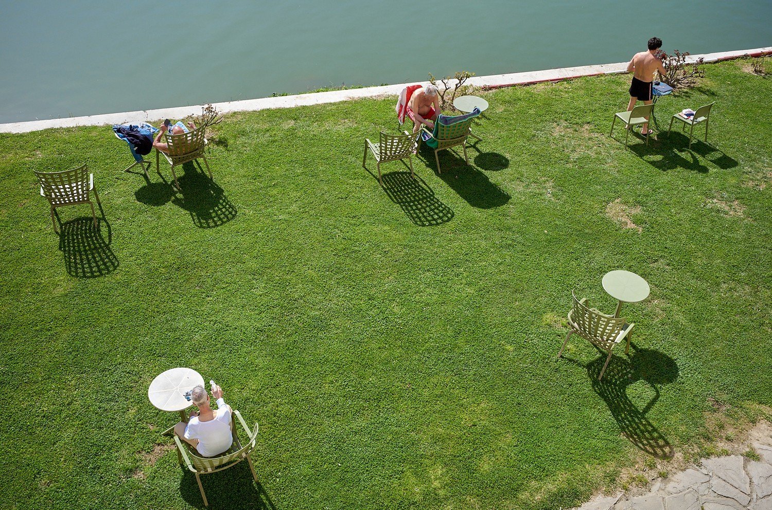 people sitting at tables on the grass