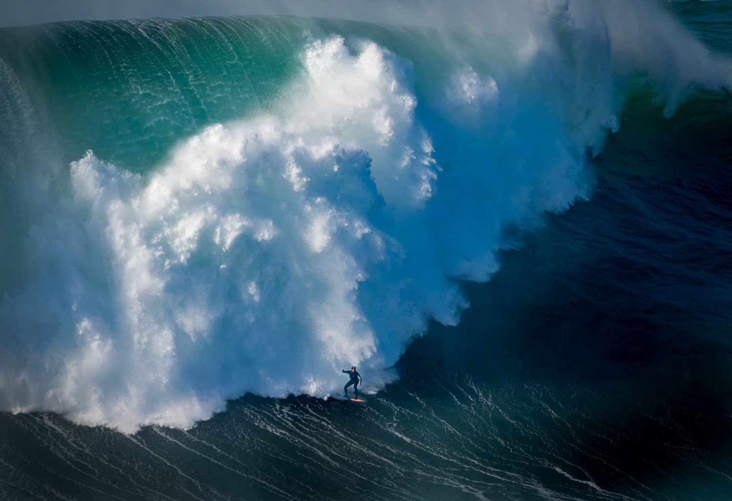 surfer facing a massive wave