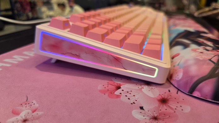 Side profile of the keyboard showing staggered keys and RGB lighting on the sides.