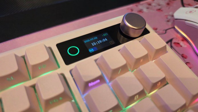 Close-up of the keyboard's LCD screen showing the light on the side, the glowing knob and the time and date on the screen.