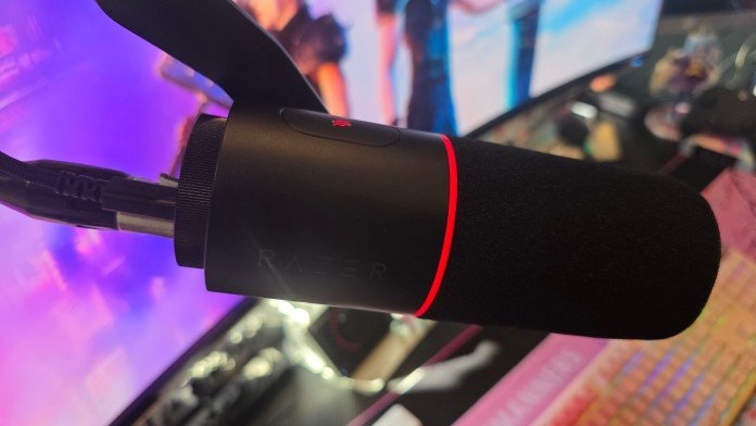 The side profile of the microphone showing the mute button illuminated red and the surrounding light on the microphone also illuminated red.