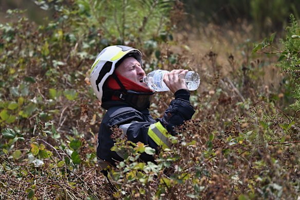 A firefighter takes a break while battling a forest fire near Le Temple, on the outskirts of Bordeaux.