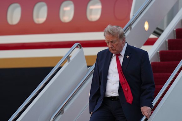 US President Donald Trump departs Air Force One on Sunday.