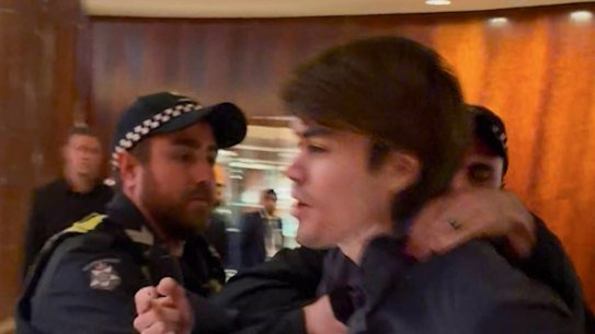 A screenshot of neo-Nazi associate Hugo Lennon being ejected by police from the Melbourne hotel where Indian Prime Minister Narendra Modi was spending the night.