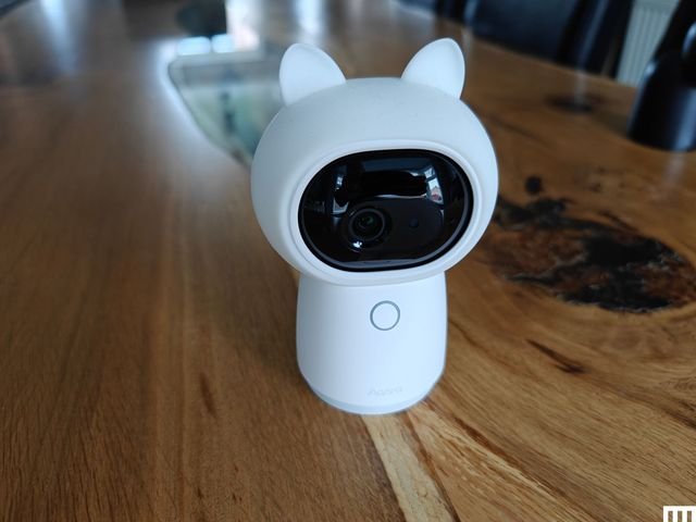Small security camera with cylindrical base, rounded center and ear shape on top