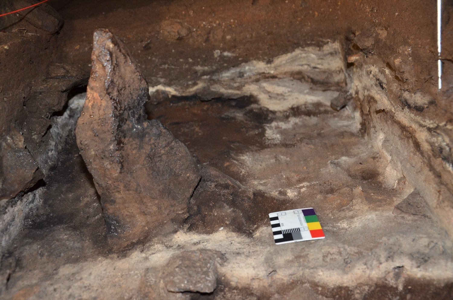 A 2,000-year-old monolith, depicted during excavations. The burned phytoliths come from the ash layers surrounding the monolith.