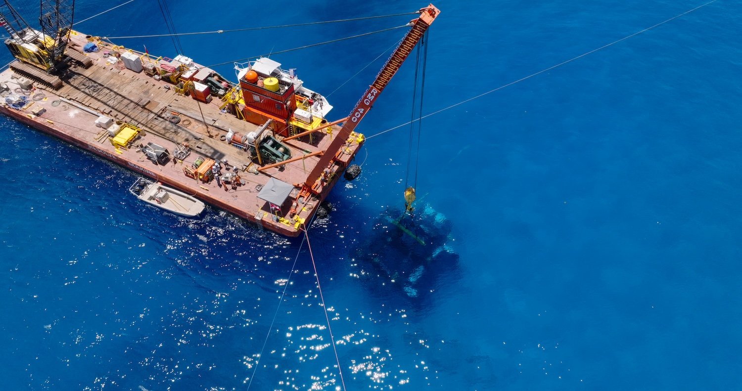 Maritime crane lowering Vanguard underwater