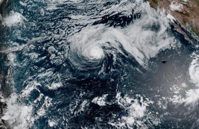 Hurricane Genevieve roars in the Pacific as Fausto weakens into a tropical storm