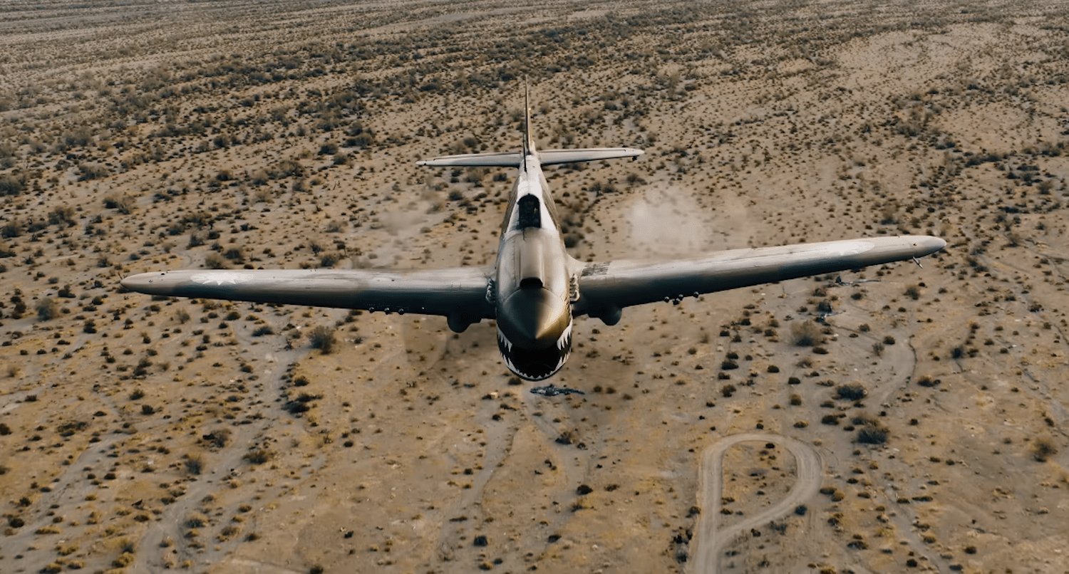 Front view of P-40 Warhawk in flight over the desert