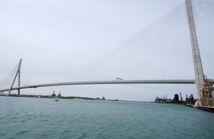 The bridge between the United States and Canada has been under construction for years. But the tension between countries is undermining the joy