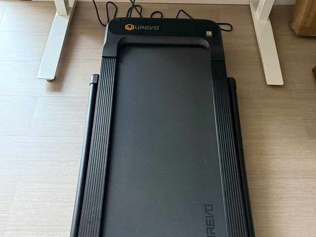 Overhead view of the Urevo Strol 2S Pro treadmill, a black walking platform under a standing desk