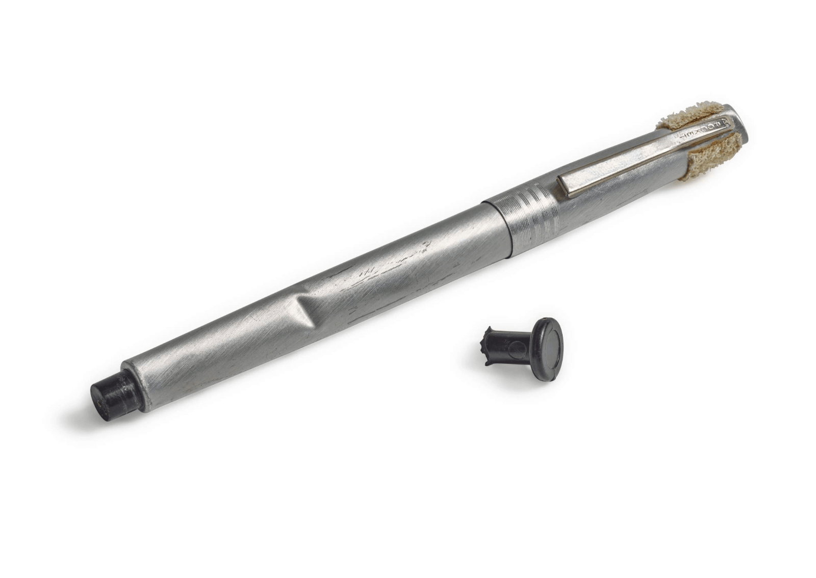 a silver pen next to a gray switch