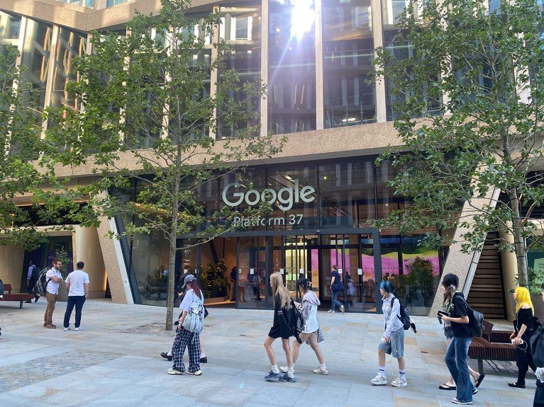 Exterior view of the main entrance of the Google building, platform 37 with pedestrians walking.