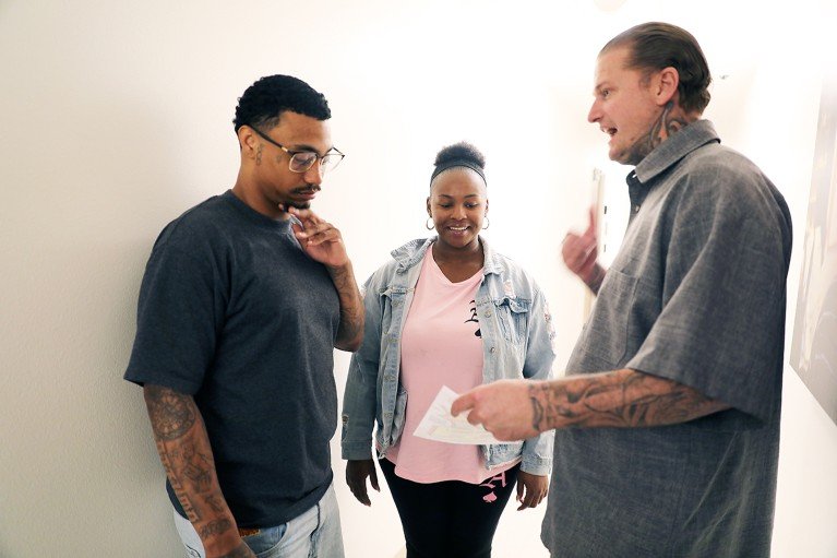 Ryan Rising talking to two young people.