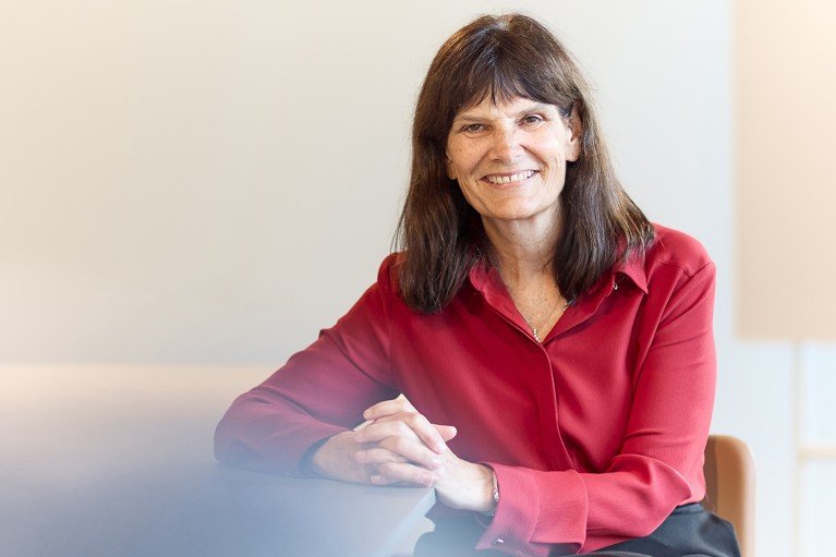 Kathleen Fisher sat at a table for a formal portrait.