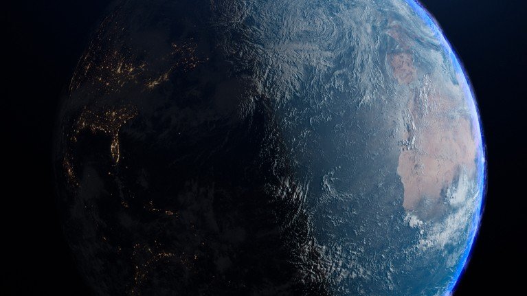 An illustration of the Earth from space, divided between day and night.