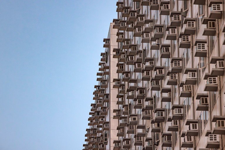 The side of an apartment building in Manila covered in air conditioning units.