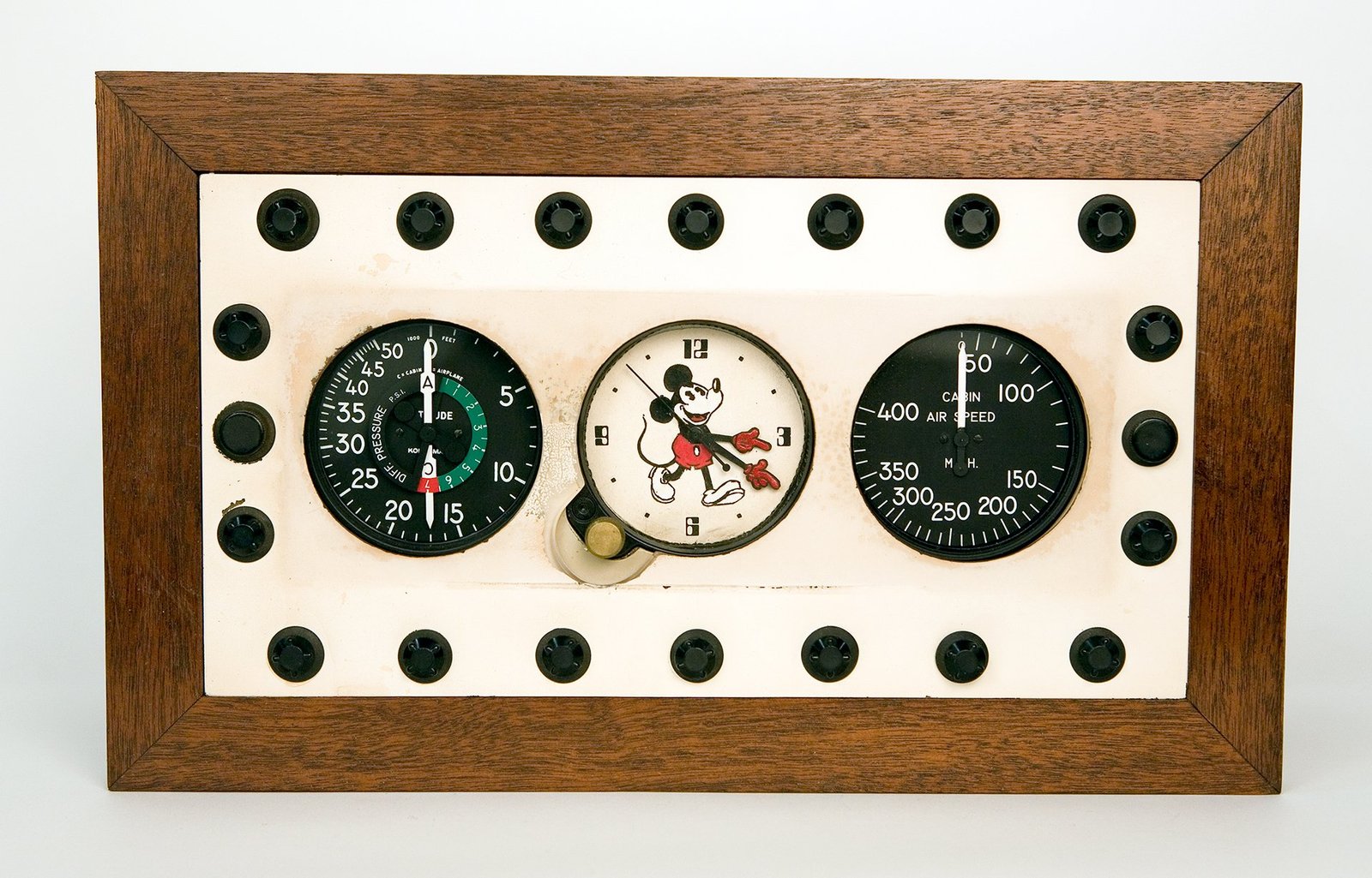 an airplane instrument panel with a clock with Mickey Mouse in the middle