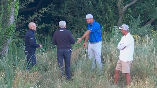 Bryson DeChambeau speaks with officials after his round Friday at the British Open.