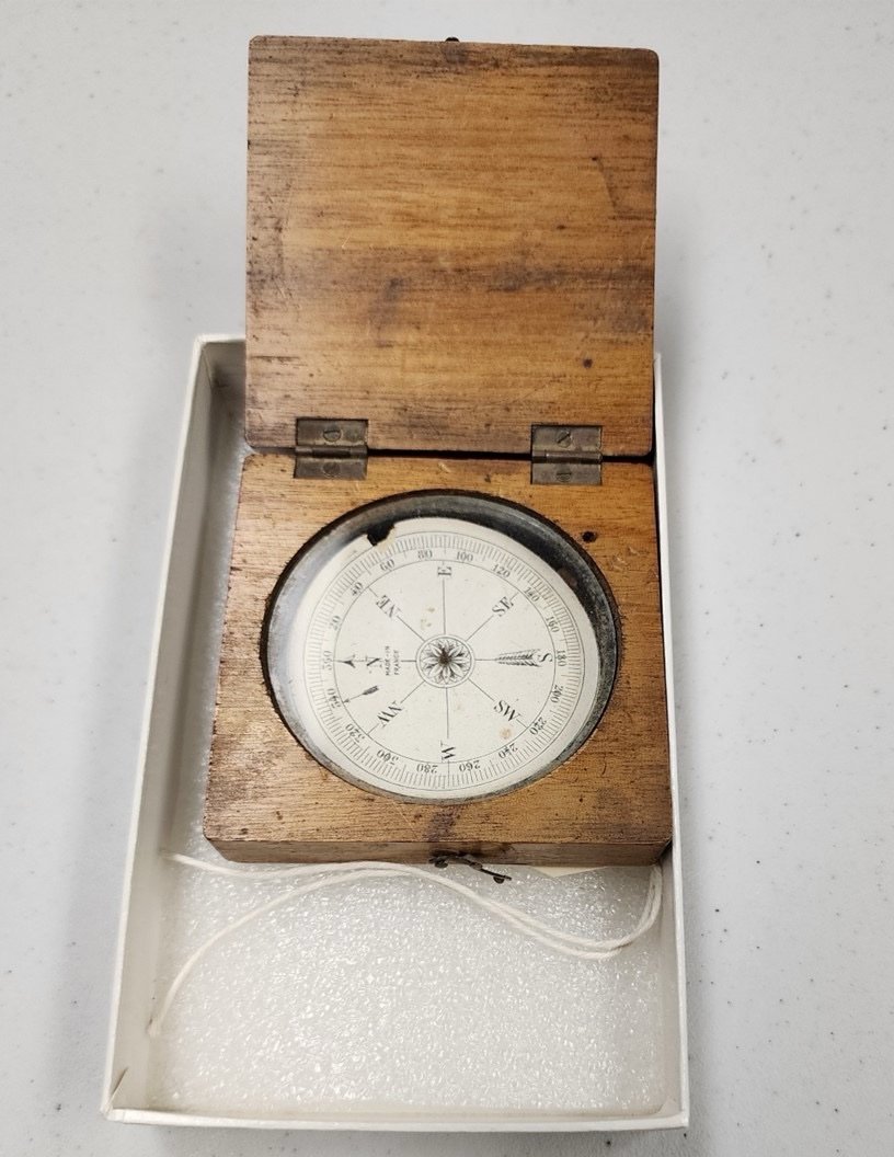 a compass in a wooden box