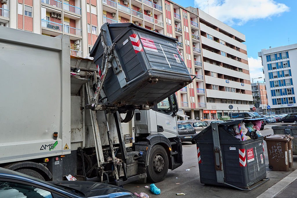 A garbage truck collects unsorted urban waste. The editorial image shows a garbage truck during the automated emptying of a container containing unsorted municipal solid waste. The photo highlights the waste collection process in urban areas and the importance of efficient waste management systems to maintain city cleanliness and environmental sustainability in Bari, Italy, on October 8, 2025. (Photo by Matteo Della Torre/NurPhoto via Getty Images)