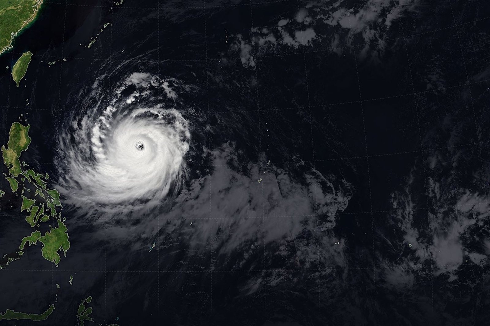 The spiraling clouds of Super Typhoon Bavi appear over the Philippine Sea southeast of Taiwan. The storm's westward track is shown in colors corresponding to the wind speed.