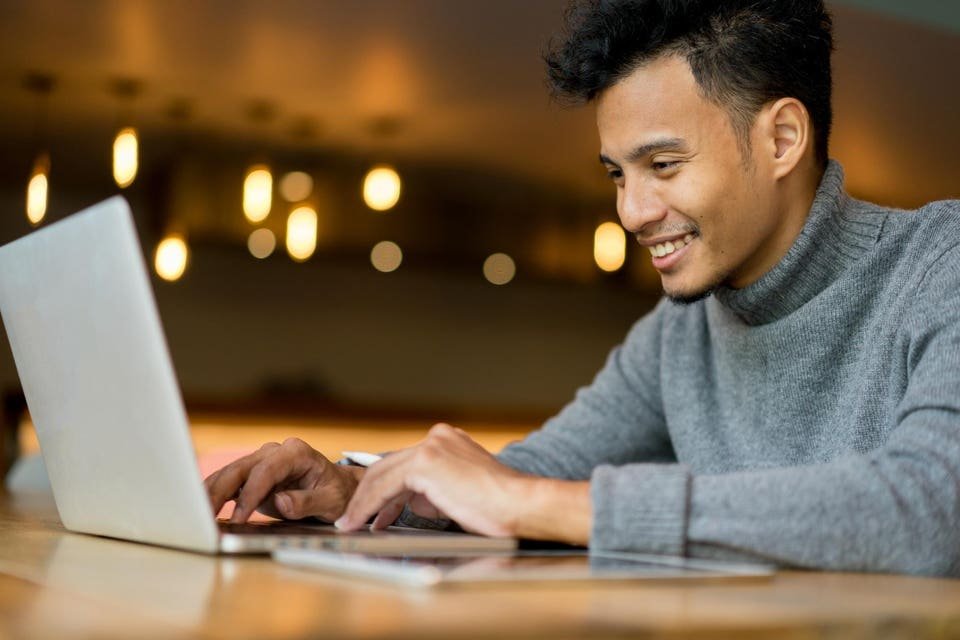 close up businessman typing on keyboard laptop at loft office for search data information and knowledge on web browser concept