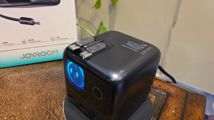 140W power charger, Two retractable cables on top that are sitting snuggly in.