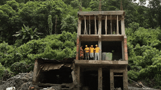 Rescue teams pick through the wreckage of a building in Dhunge.