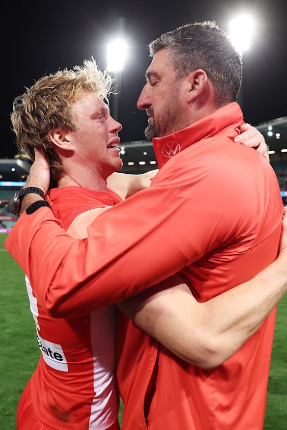 Sydney captain Callum Mills and coach Dean Cox embrace after Sunday’s win over North Melbourne.