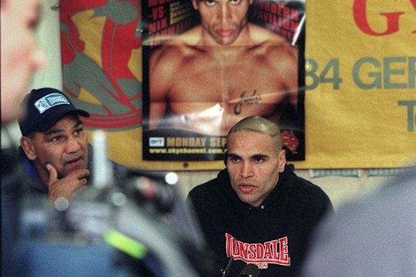 Anthony Mundine speaking at a press conference promoting his next fight with his father Tony Mundine next to him.