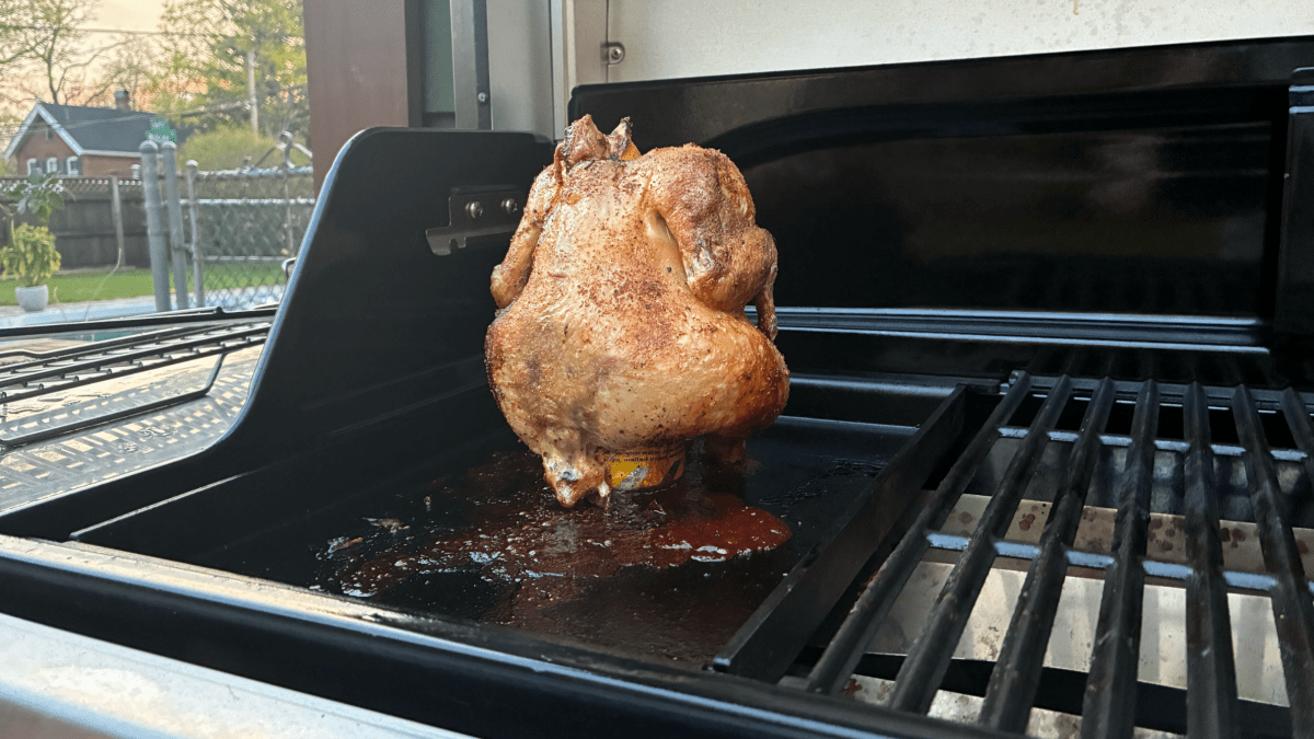 chicken cooking on griddle with grease pouring out