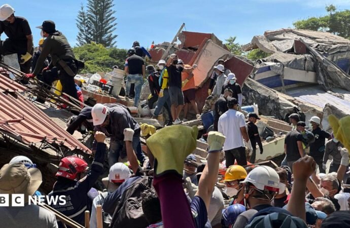 Anguish of Colombian brother at rubble of building being searched for earthquake survivors