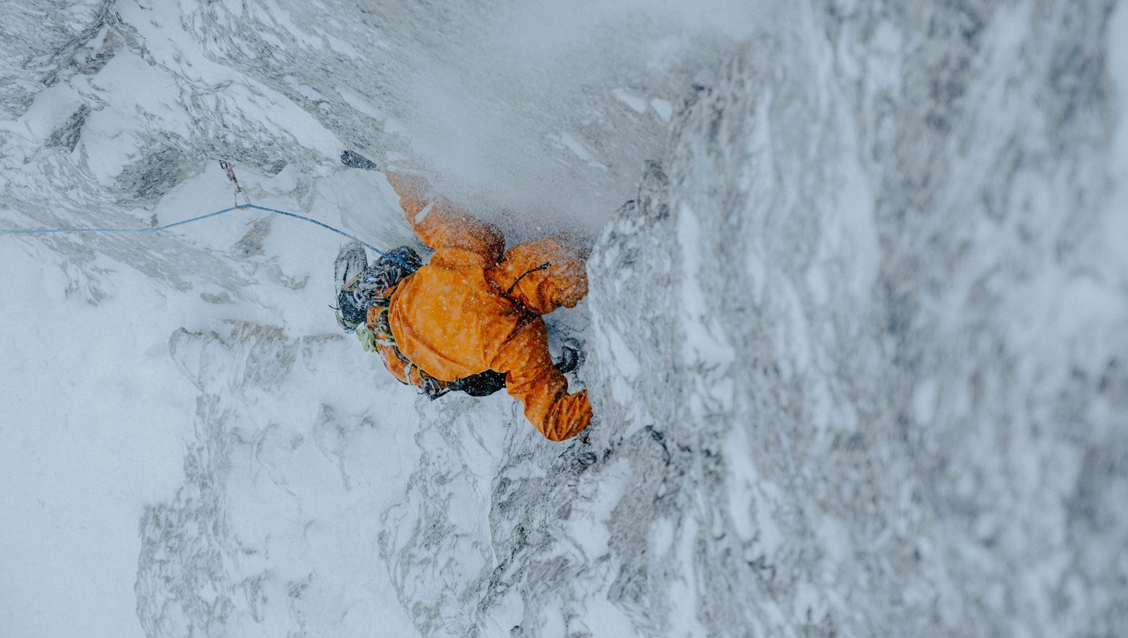 A person climbing an ice wall in an Arc'teryx Sperro SV jacket
