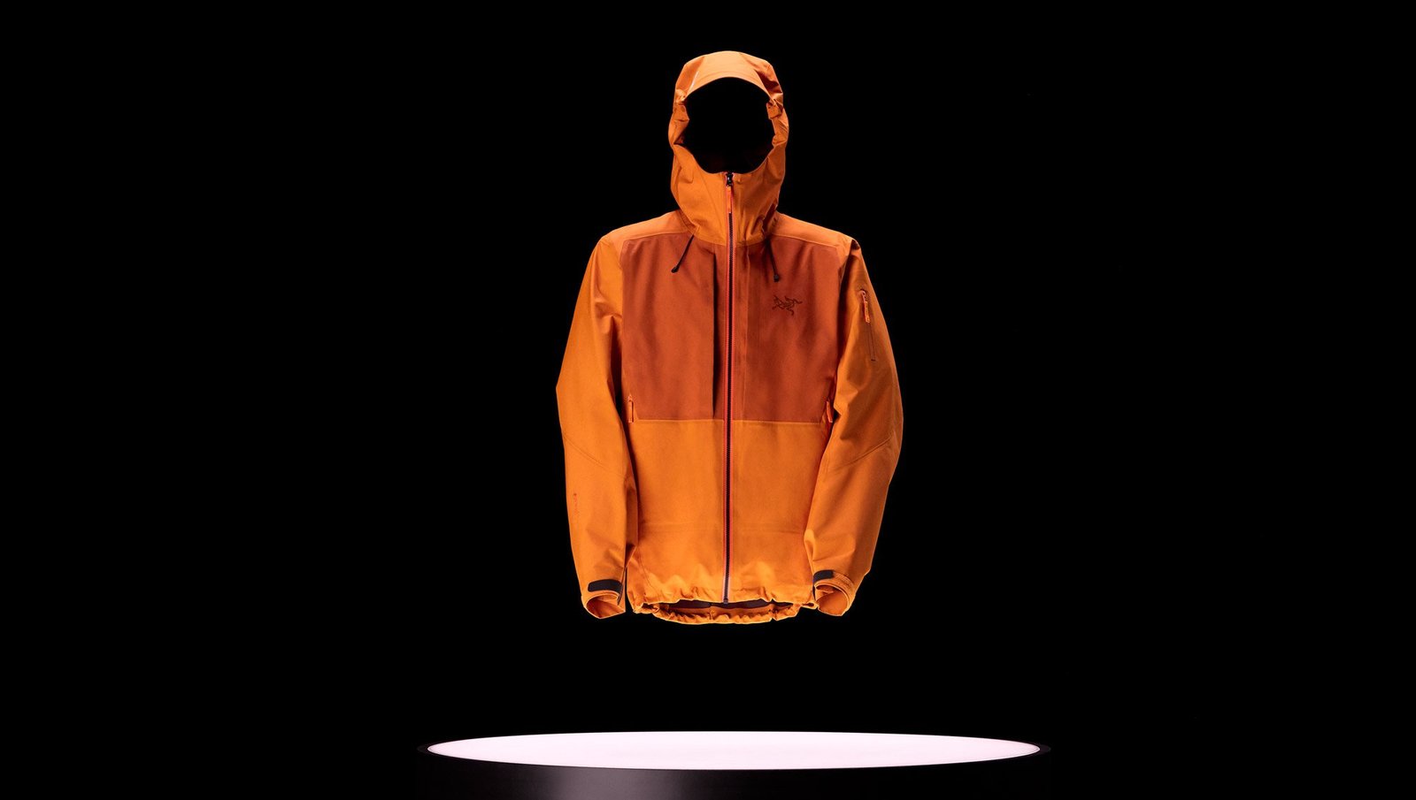 A Arc'teryx Sperro SV jacket on a black background with a light underneath it