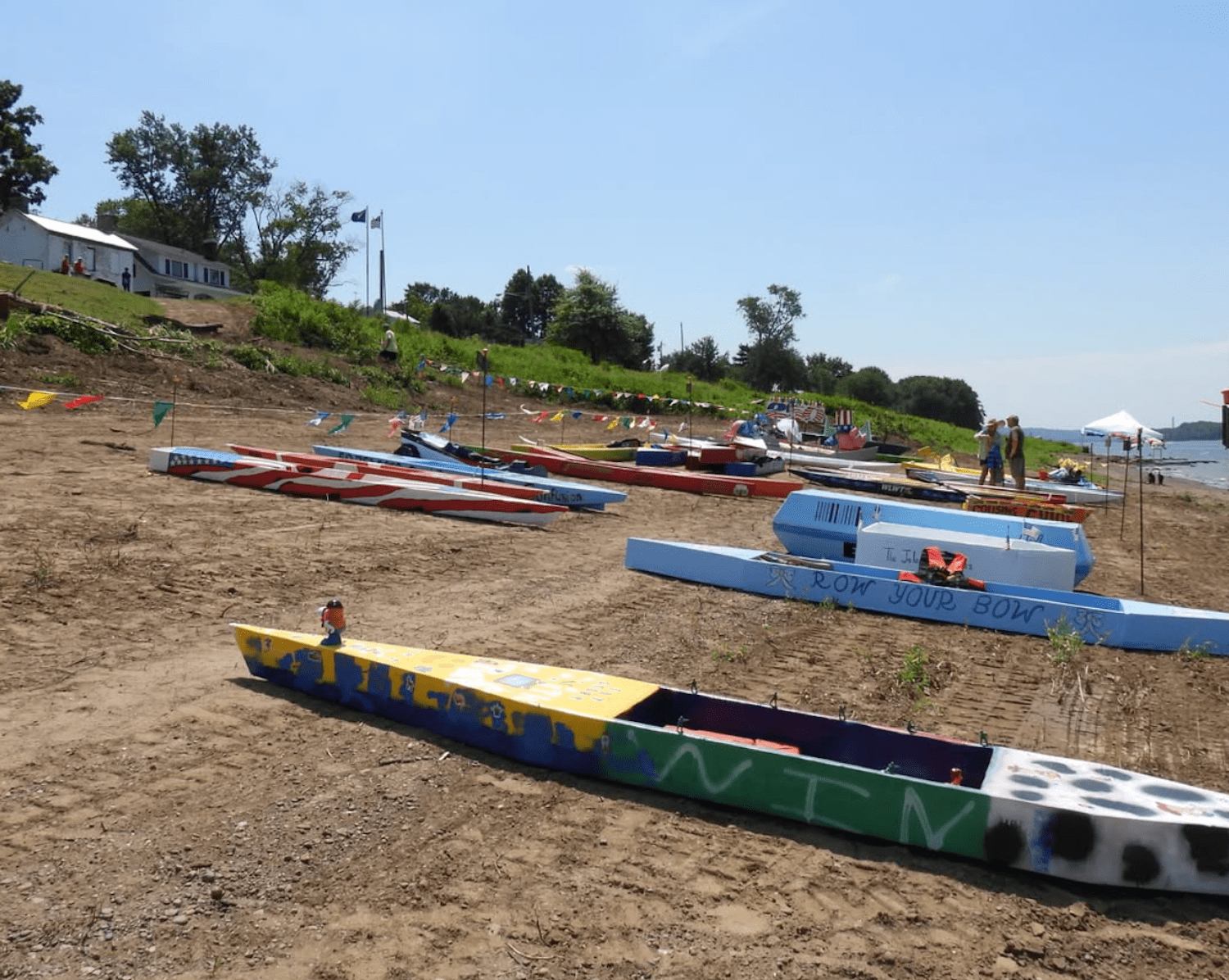 Cardboard boats on river shore