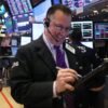 Dow surges to record close after fresh tech rally and a plunge in oil prices