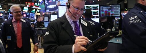 Dow surges to record close after fresh tech rally and a plunge in oil prices