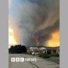 Fast-moving Canada wildfire doubles in size forcing thousands to flee homes