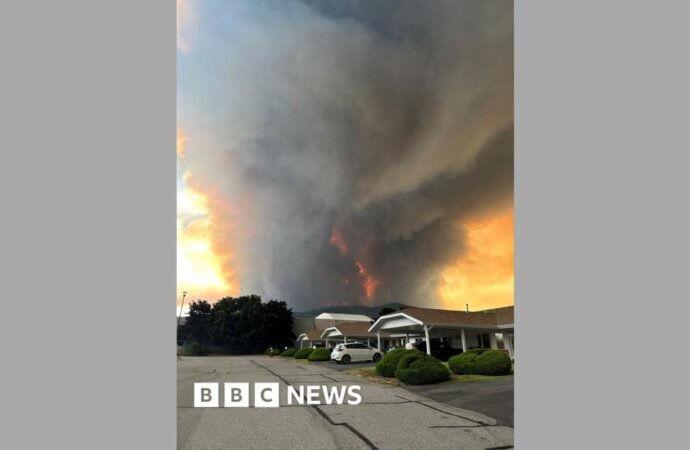 Fast-moving Canada wildfire doubles in size forcing thousands to flee homes