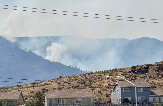 Firefighters are trying to stop a fast-moving Nevada wildfire from spreading to homes in Reno