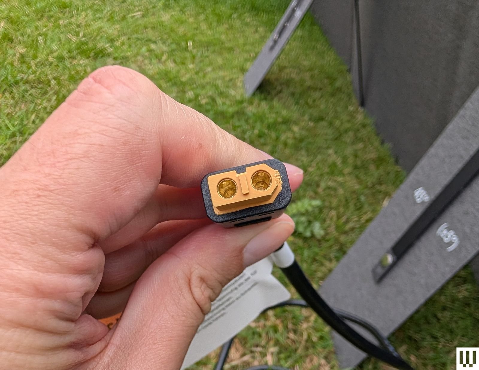 Image may contain Adapter Electronics Body Part Finger Hand Person Grass and Plant