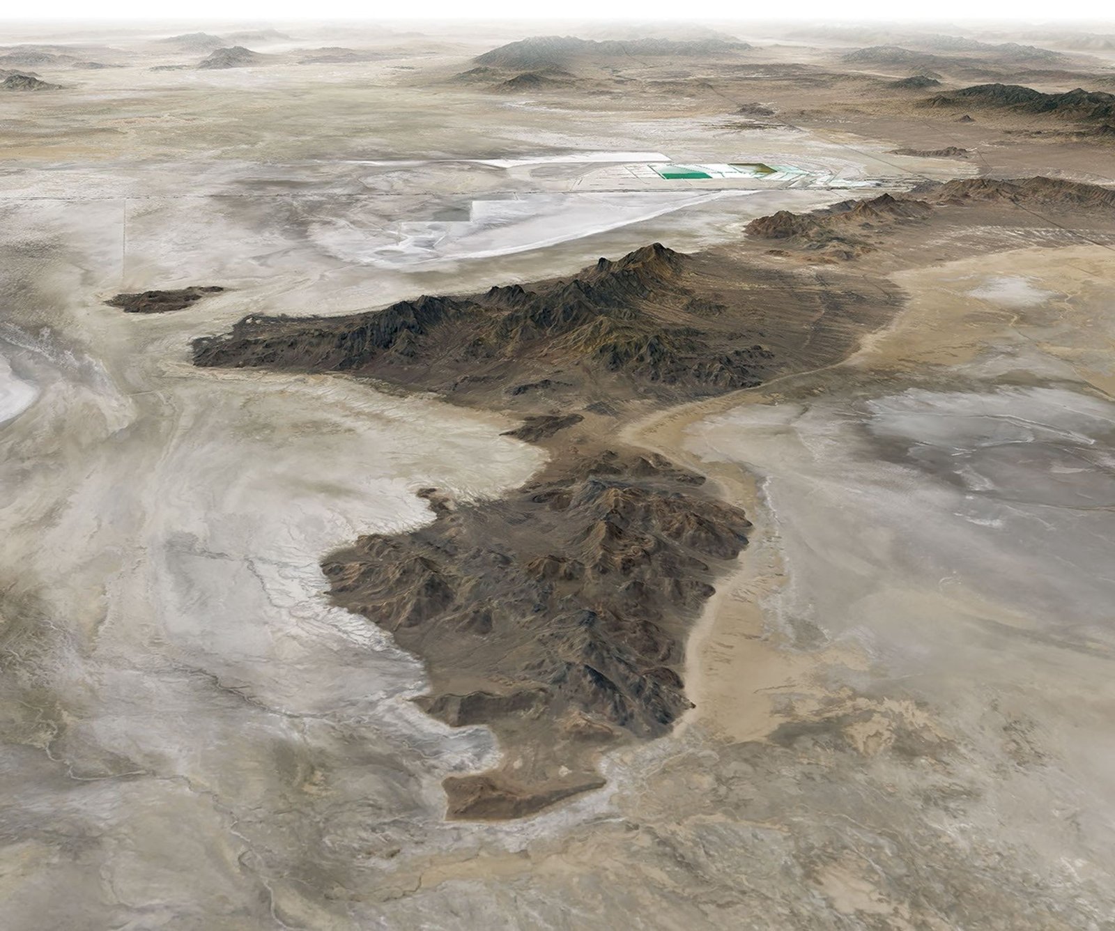 Tan and white plains surround a dark mountainous ridge in a three-dimensional image of the Silver Island Mountains.