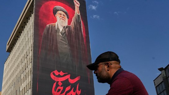 A Tehran billboard with a message that reads in Farsi, “We must rise up”, and an image of the late Iranian supreme leader Ayatollah Ali Khamenei.