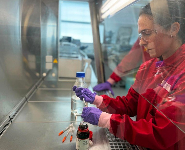 Emma Yates manufacturing Enlighten® kits inside a laboratory fume hood.