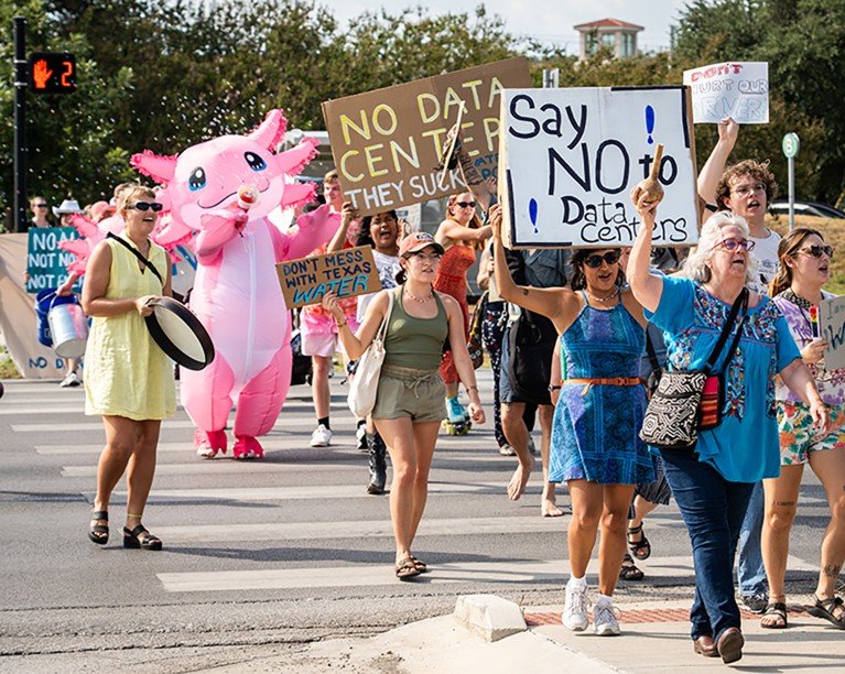 Protesters hold signs and march against proposed data centres in their area.