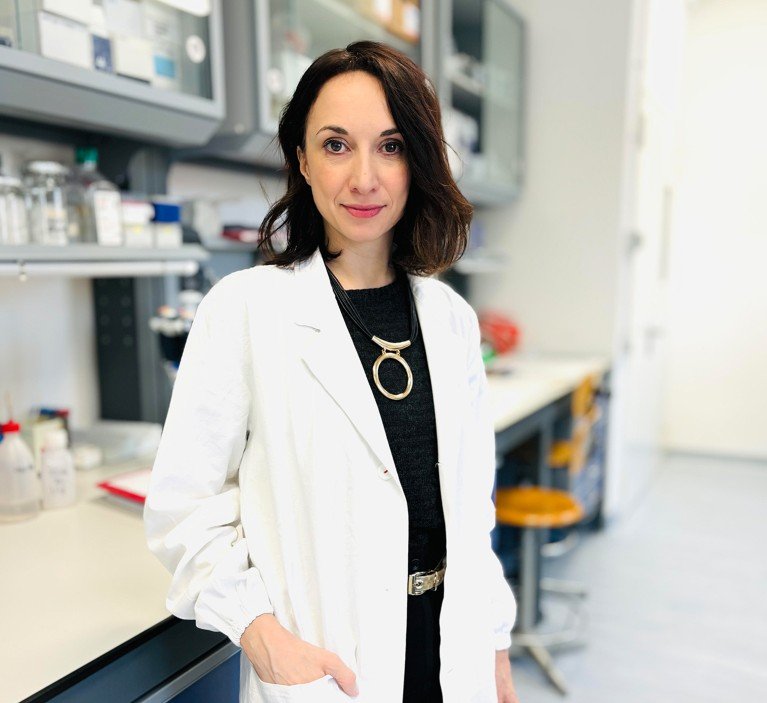 Francesca Granata wearing a labcoat in her laboratory.