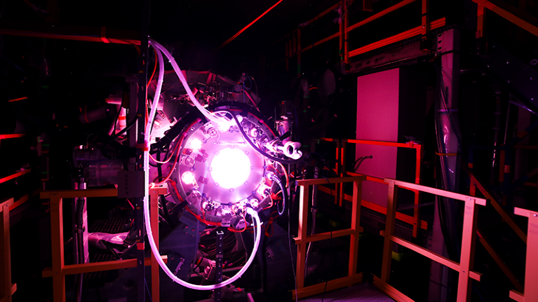 dark room with purple glowing equipment in the centre