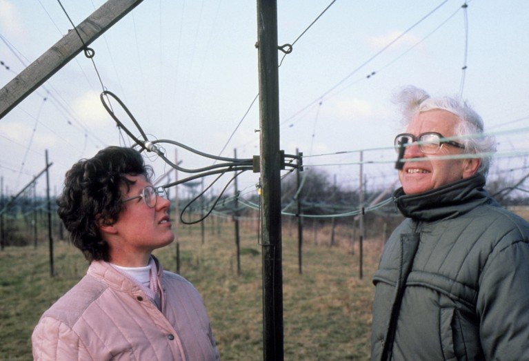 Astronomers Jocelyn Bell Burnell and Anthony Hewish outside with the wires and radio telescope that discovered the first pulsar, in England, 1967.