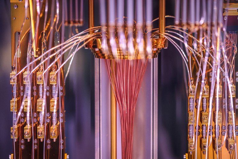 Close-up of a quantum computing demonstration featuring illuminated circuitry and advanced computing hardware.